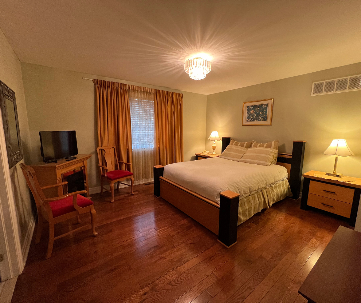 Elegant bedroom with queen bed and warm lighting