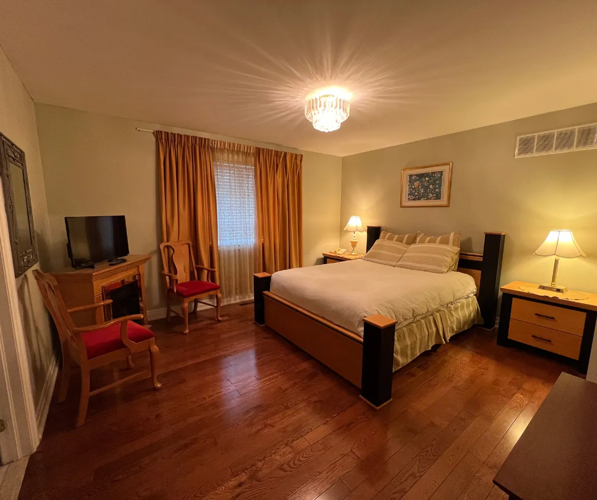 Elegant bedroom with queen bed and warm lighting