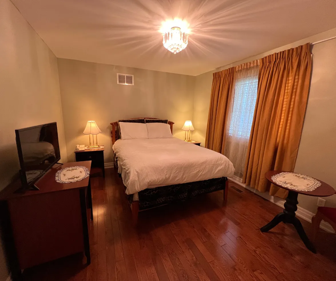 Cozy bedroom with queen bed and warm lighting